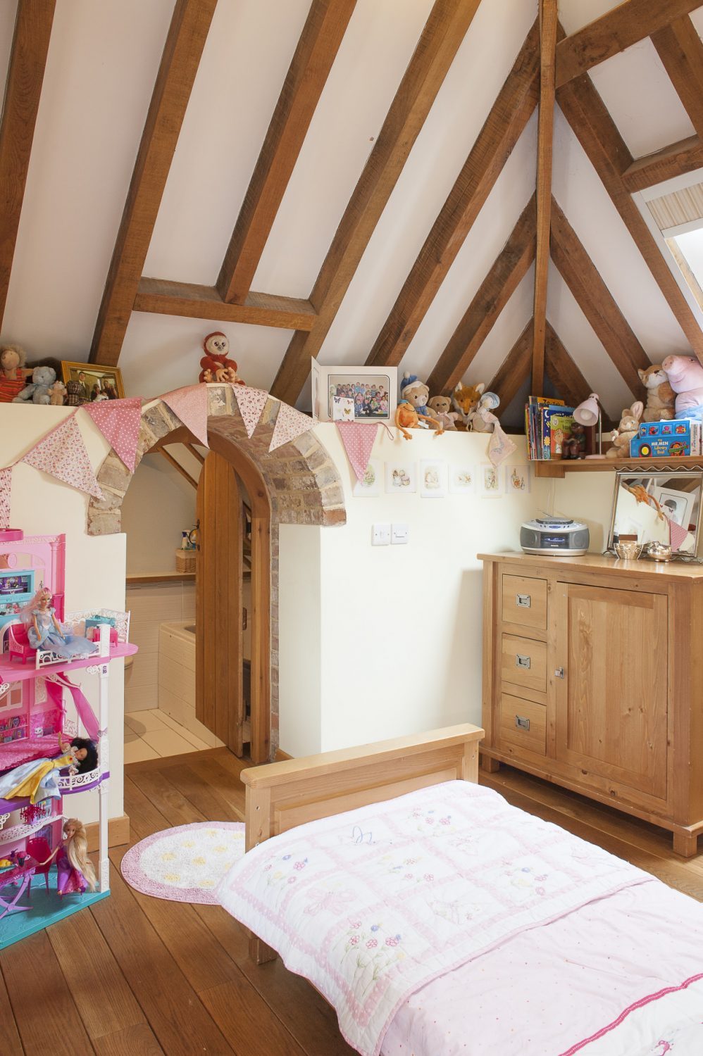 Katie has her own bathroom, accessed through a tiny child-sized doorway in her room. The floors are oak with – as elsewhere – underfloor heating powered by an air-source heat pump
