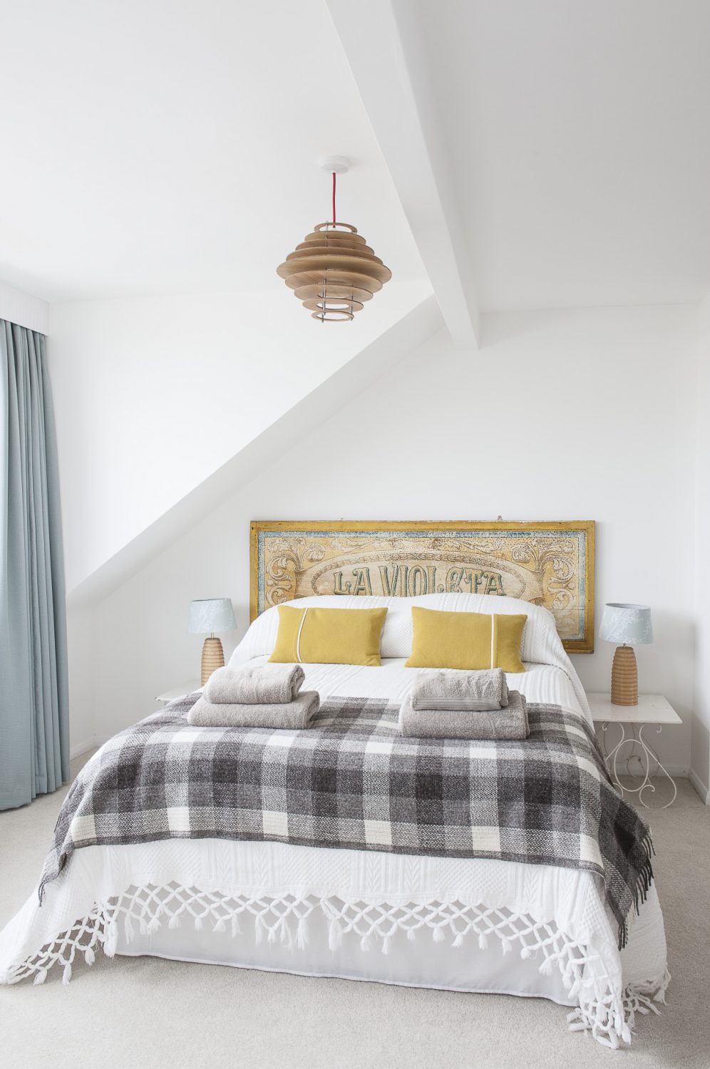 An old fairground sign from France forms a bedstead in the master bedroom