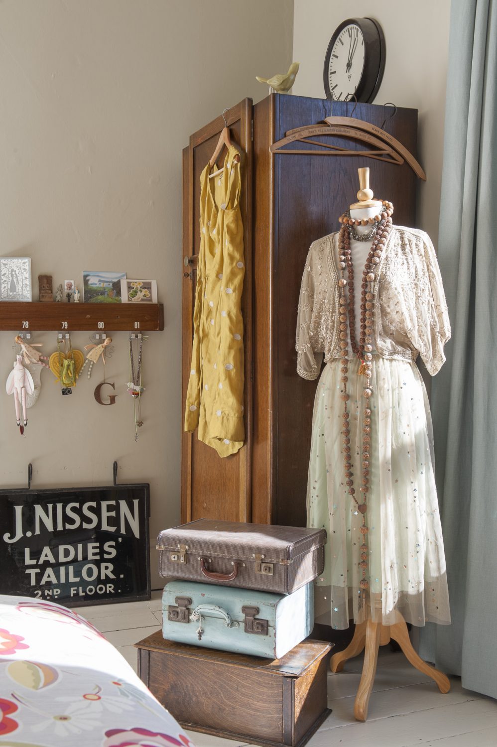 Along the landing, the main bedroom has a stack of vintage cases and boxes and a classic late 1930s oak wardrobe that belonged to Sarah’s grandad