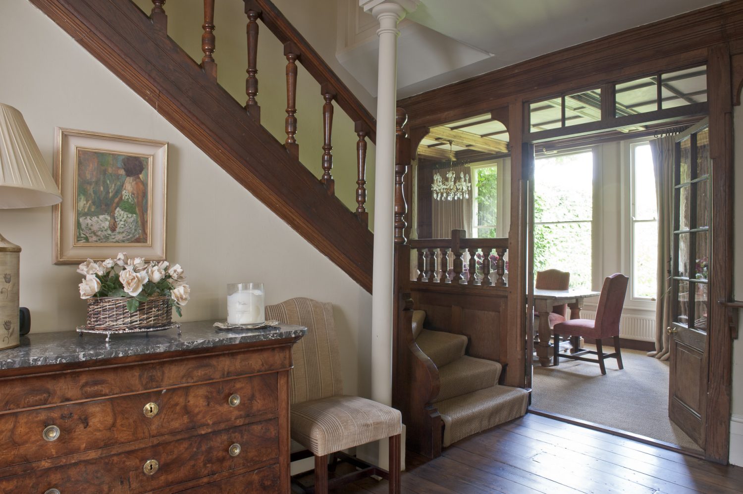 The stately windows allow light to flood into this room illuminating the wood-panelled walls