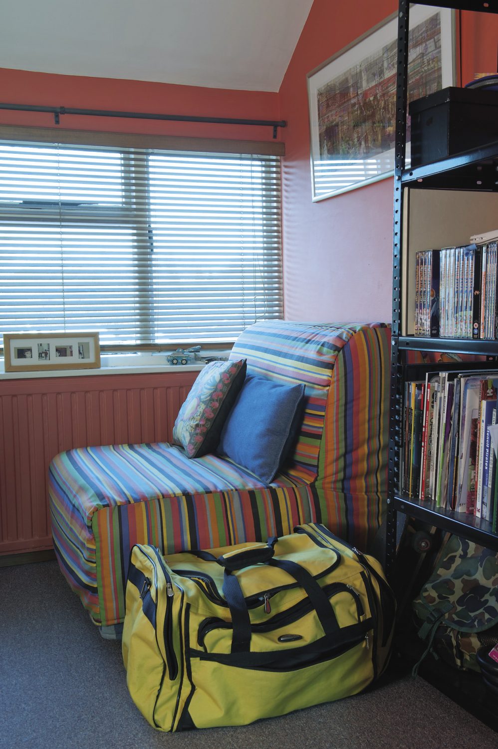 The couple’s son’s room already shows all the telltale signs of the architectural student. Every item of furniture is placed at right angles to the watermelon red walls (architects never seem to place anything on the diagonal) and there is a striped chair in front of the window where curtains have been rejected in favour of simple wooden Venetian blinds