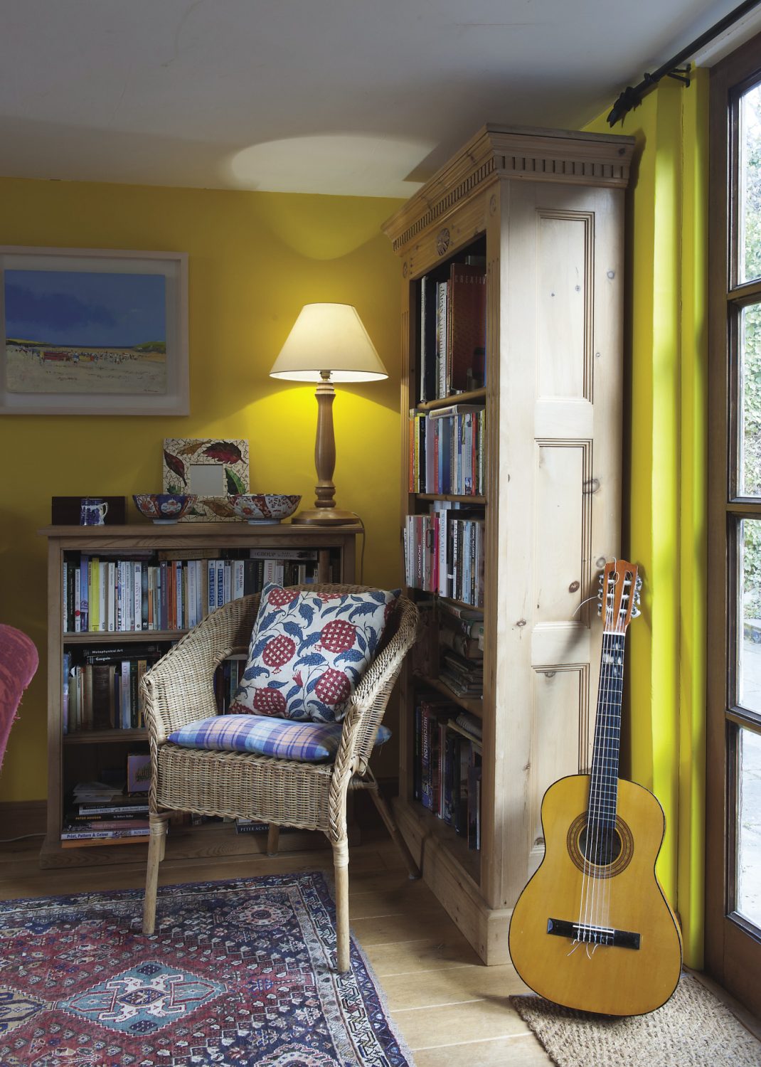 An accoustic guitar propped in one corner alludes to Oliver’s phenomenal music collection