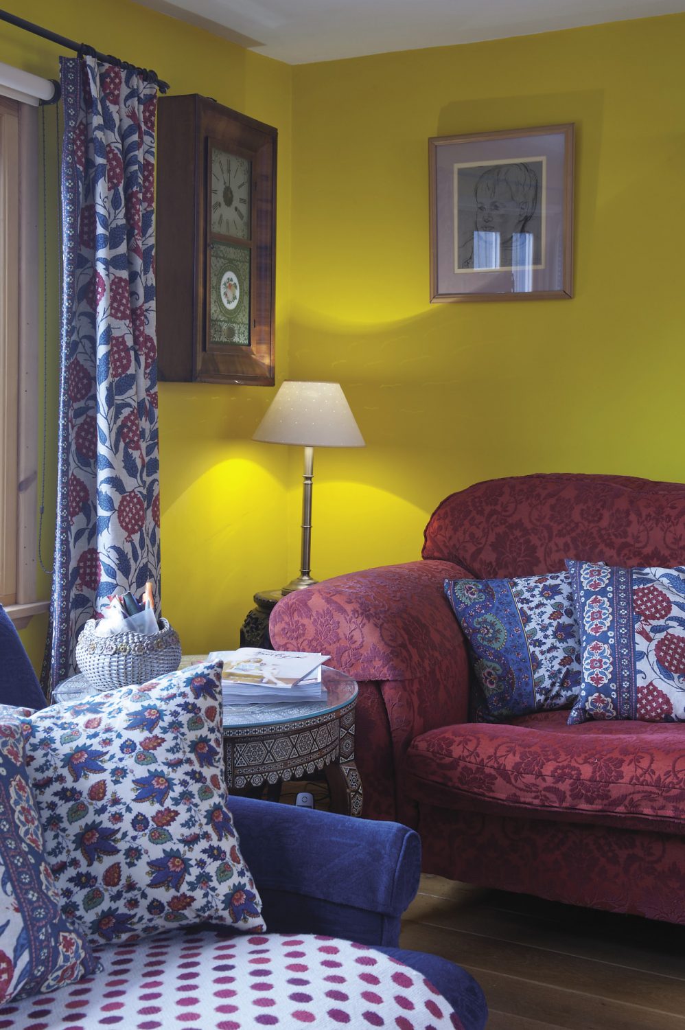 In the sitting room bookshelves are crammed with art and design books. The three sofas are draped with woven woollen throws and an assortment of cushions including some that are covered in a heavy cotton printed with a pomegranate motif, a fabric that Fiona found at Hoopers in Tunbridge Wells
