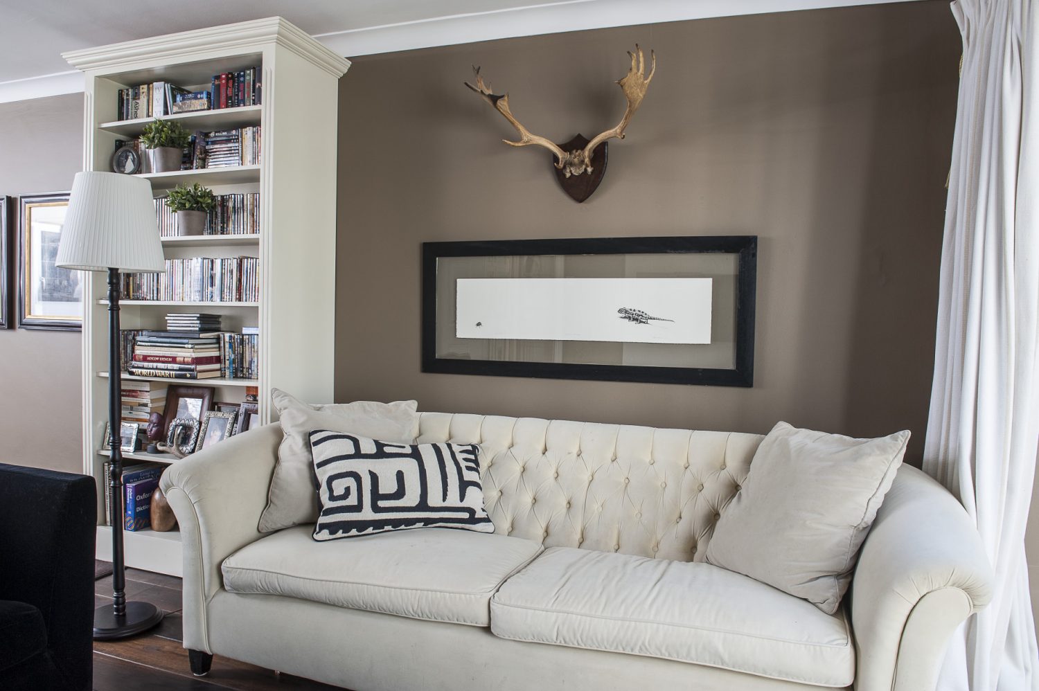 In the children’s room sofas – one stone, the other black – lounge around a huge TV. On the wall opposite is a pair of antlers and a great wildlife print by one of the couple’s favourite artists, South African John Moore