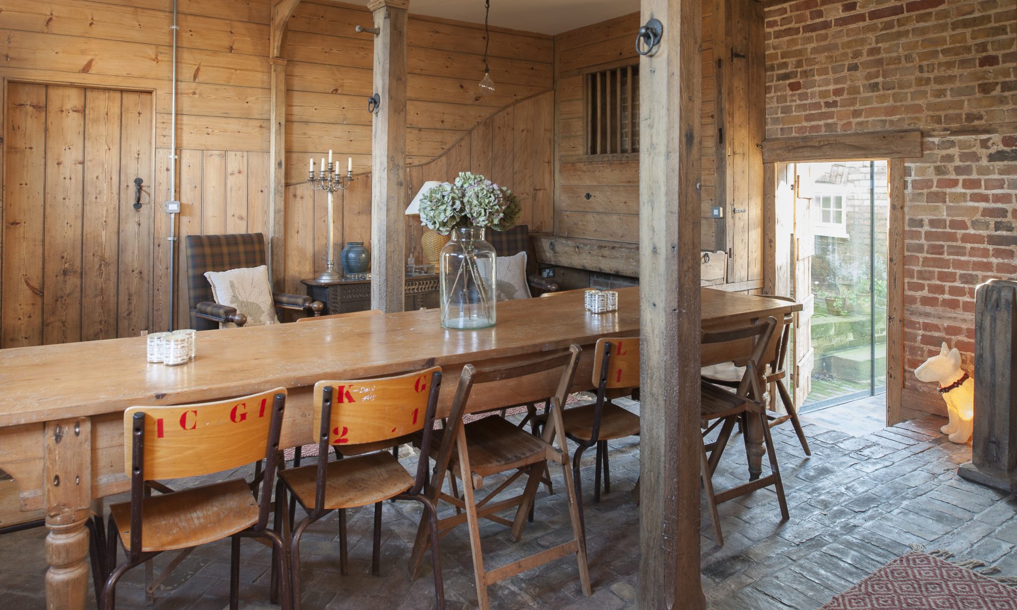 The pièce de résistance of Amy and Adrian’s conversion is the coach house. At one end of the room are the original hay feeders and mangers, now, like all the woodwork, sandblasted and pristine