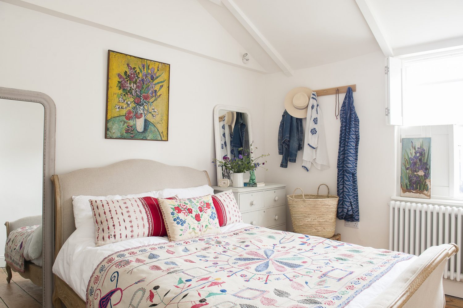 Helen’s bedroom is a gloriously pared back ‘homage to a Greek bedroom’, with white walls and shutters, a bed by Loaf, an Indian quilt and Romanian cushion and paintings from a fellow Norman Road trader