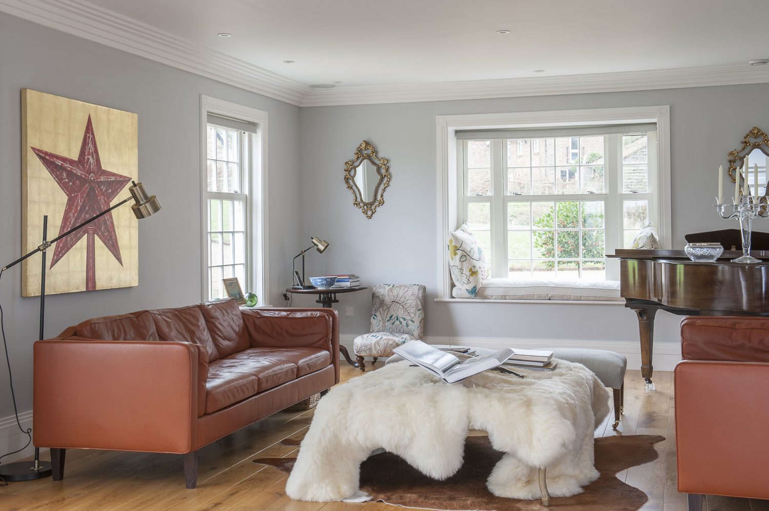 The opposite end of the living room-cum-drawing room has a different feel; perhaps more ‘rustic modern’, with luxurious sheepskins and retro leather sofas