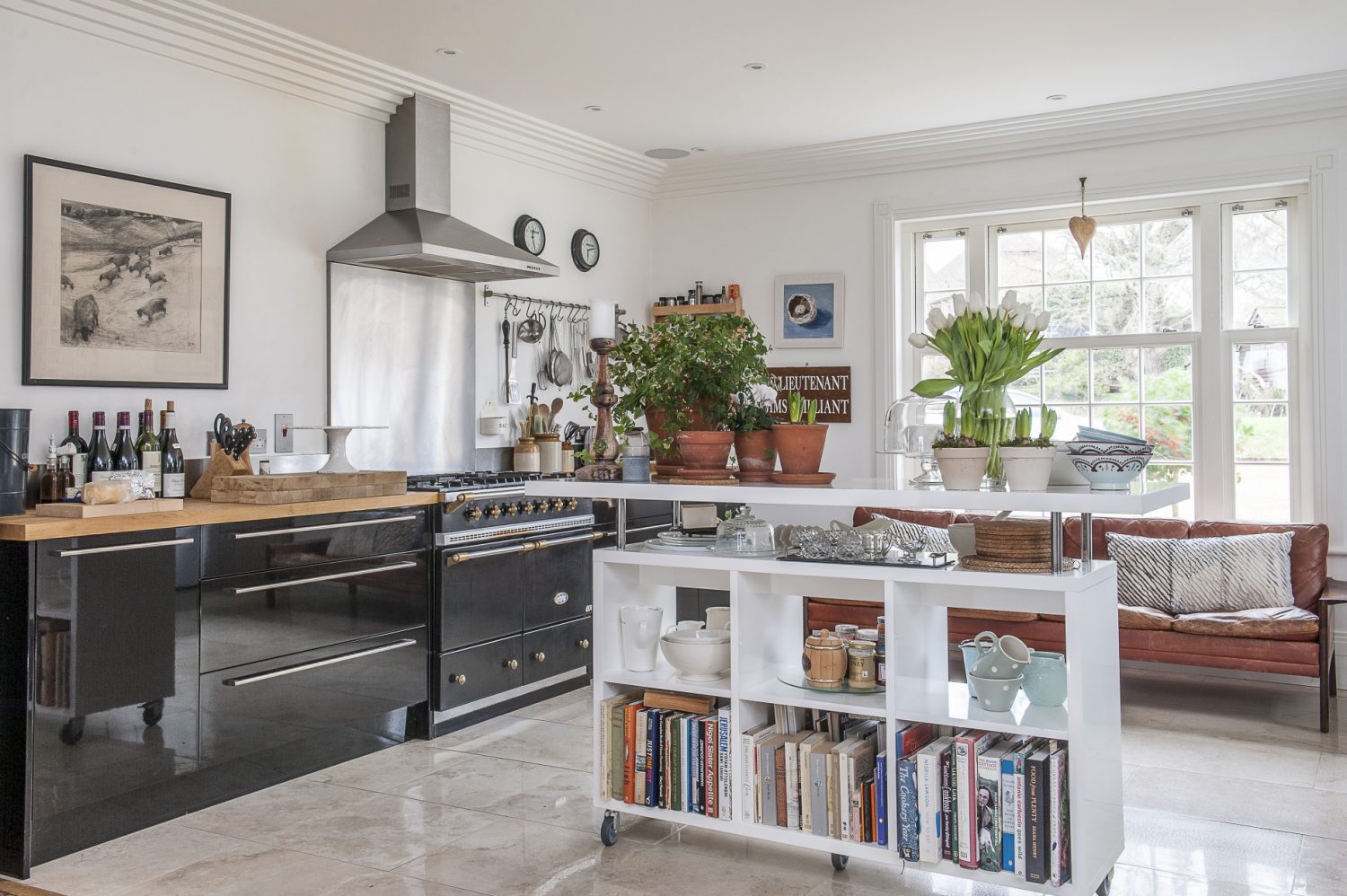 The marble floor tiles were the only feature of the kitchen in place when the Smiths bought their home. They added minimalist off-the-shelf kitchen units and a clever, mobile kitchen unit which can be moved to create more space if necessary