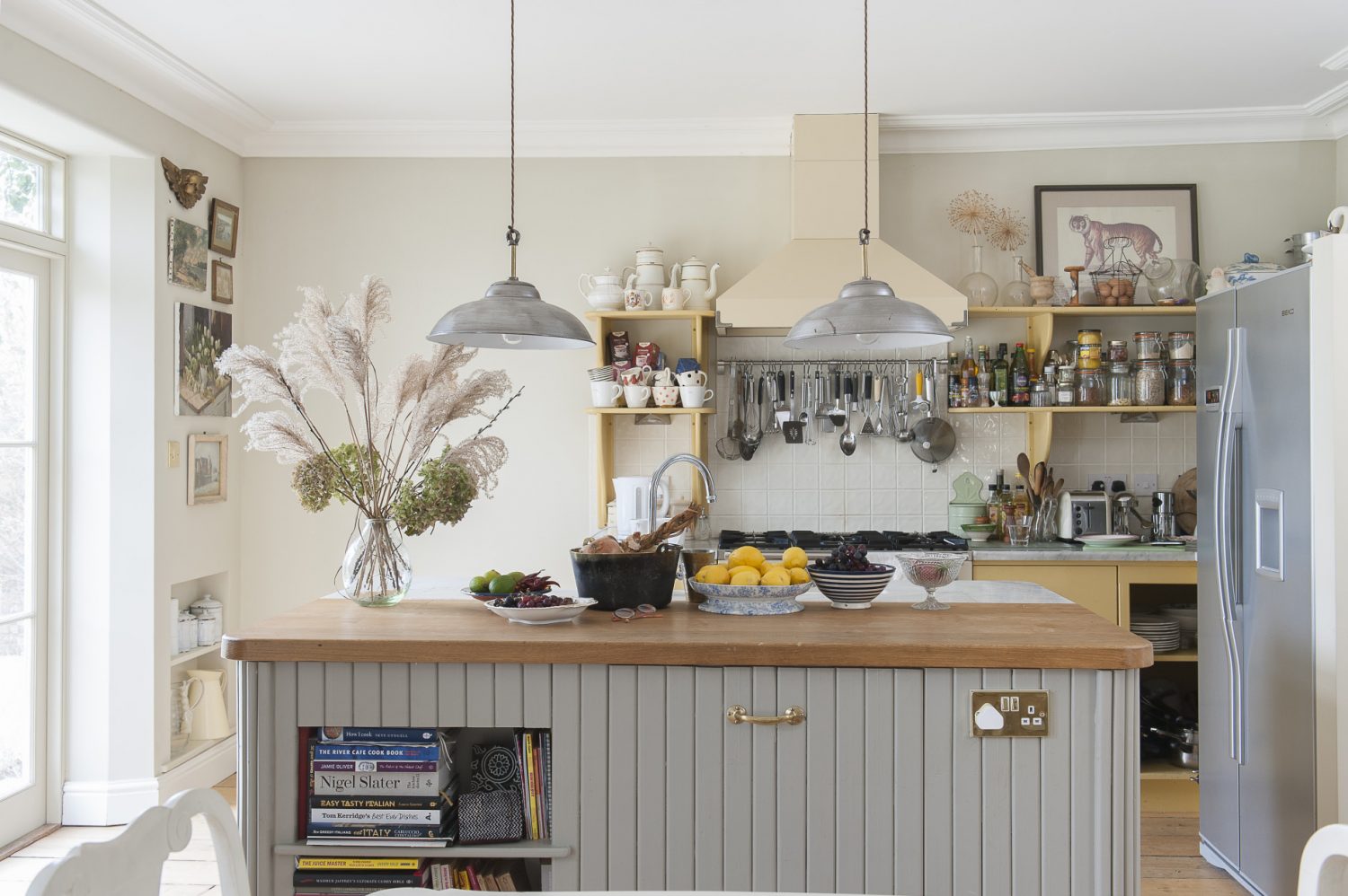 The ‘working end’ of the kitchen is a cook’s dream, with utensils and ingredients close to hand and an island unit – with half-oak-half-Carrara marble surface – allowing Emma to talk to guests while preparing food. The warm yellow of the painted shelving units is a nod to Emma’s Norwegian heritage