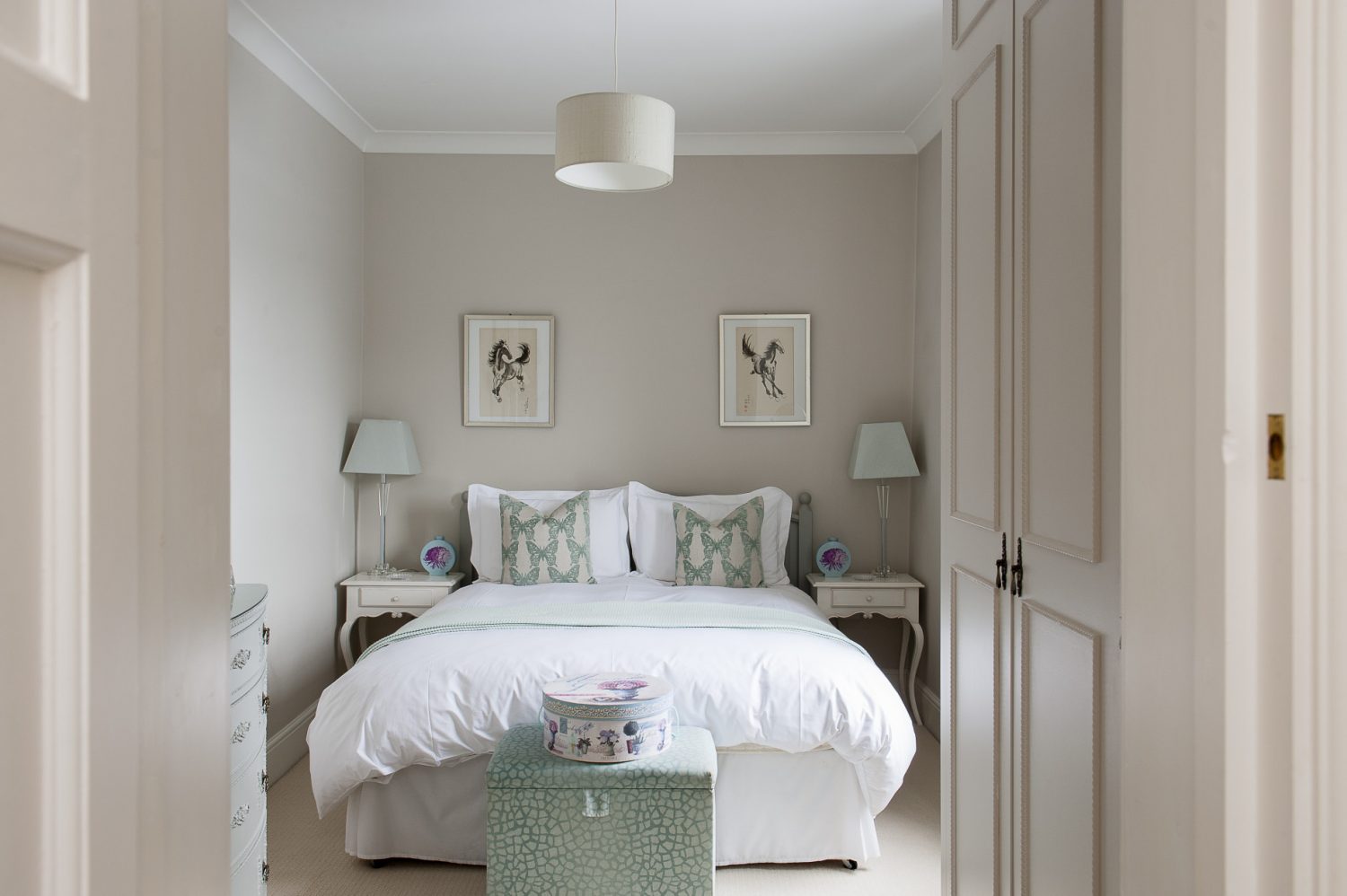 A guest bedroom features accents of robin’s egg blue