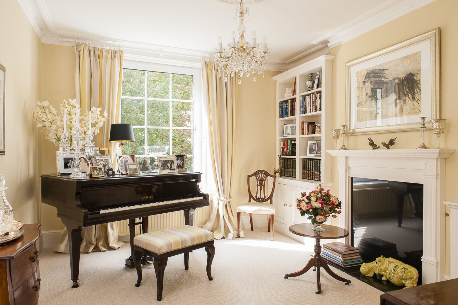 The music room walls are painted in Farrow & Ball’s Cream. Pride of place is given to the ebony Challen baby grand piano that belonged to Murielle’s mother.
