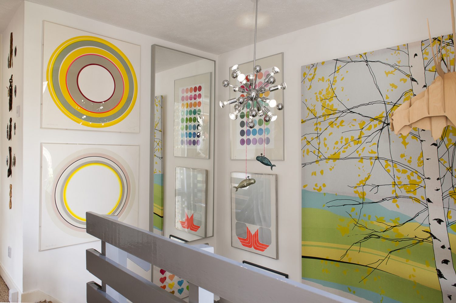 Two sizable canvases depicting large neon circles by Sam’s favourite artist, Sophie Smallhorn, hang to the left of the landing