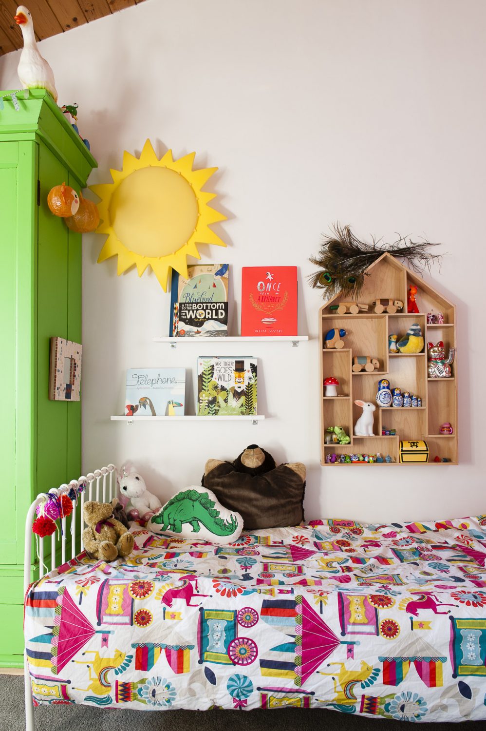 Daughter Esther’s room sports the same dramatic pitched pine ceiling as her parents’. Her wardrobe started life a plain pine but is now a bright pea green. Books and ornaments are kept neatly ordered on floating shelving
