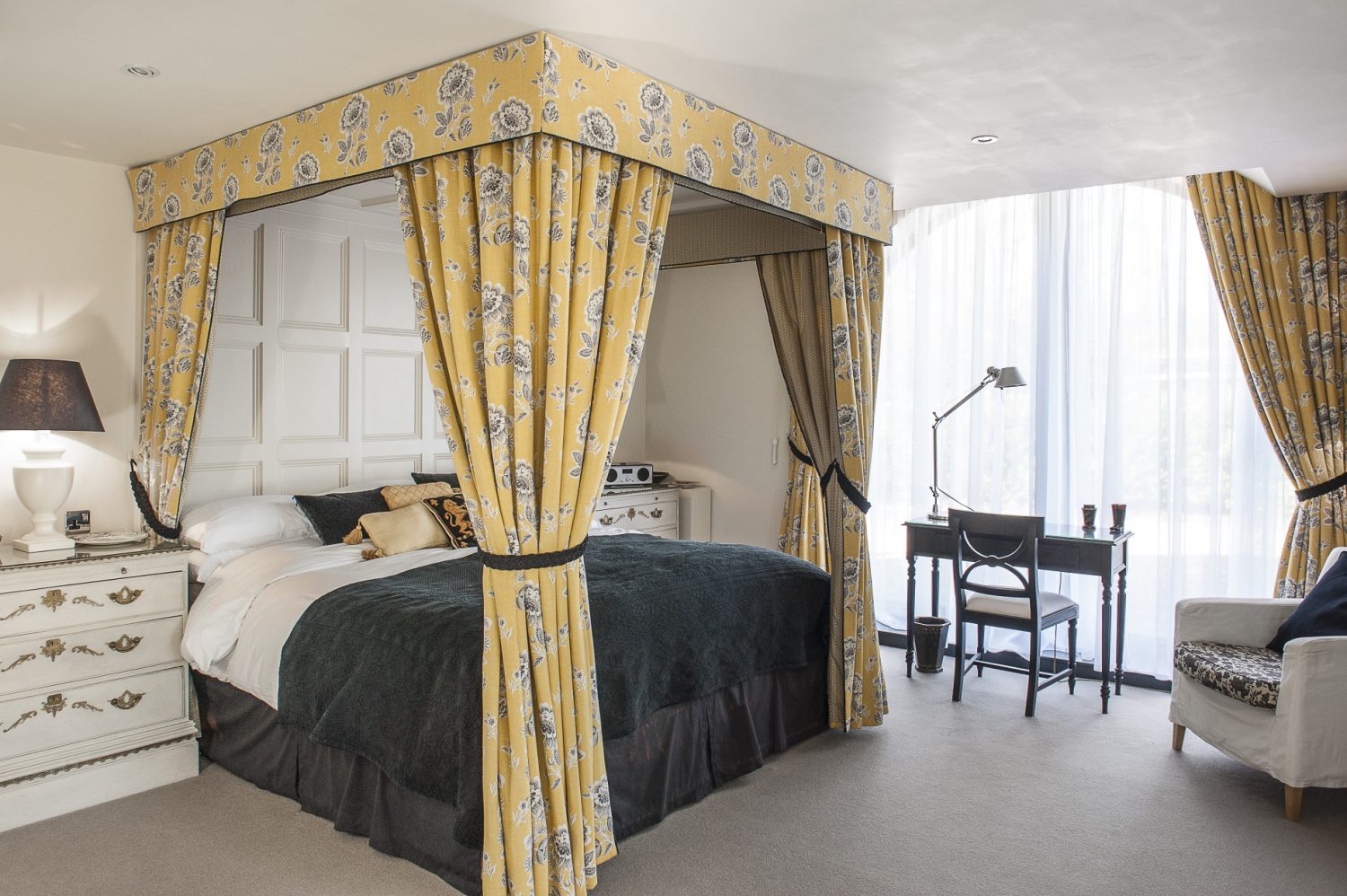 Situated in the granary, Keynes features a super king-sized draped bed and antique, painted, glass-fronted armoire