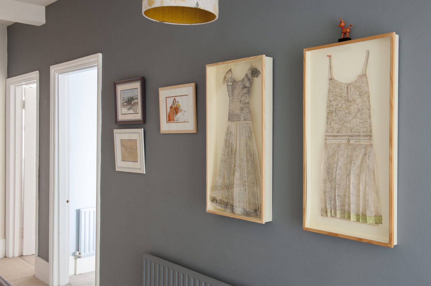 On the landing. Louise made the paper dresses out of old maps