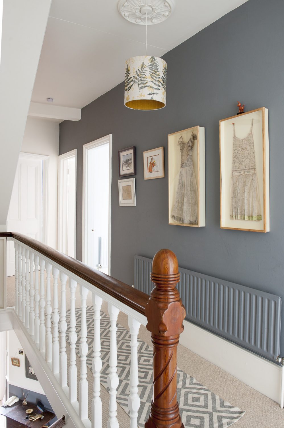 The landing wall is painted in Downpipe by Farrow & Ball. The lampshade is Louise’s design