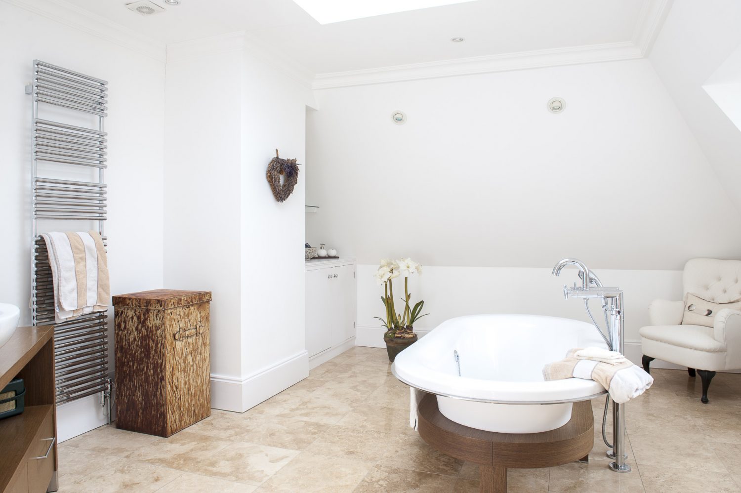Helena and Julian wanted to be able to lie in the bath and gaze up at the stars, so positioned the double-ended bath under a central skylight window. Underfloor heating and a large heated towel rail keep this generous bathroom warm, even in the depths of winter