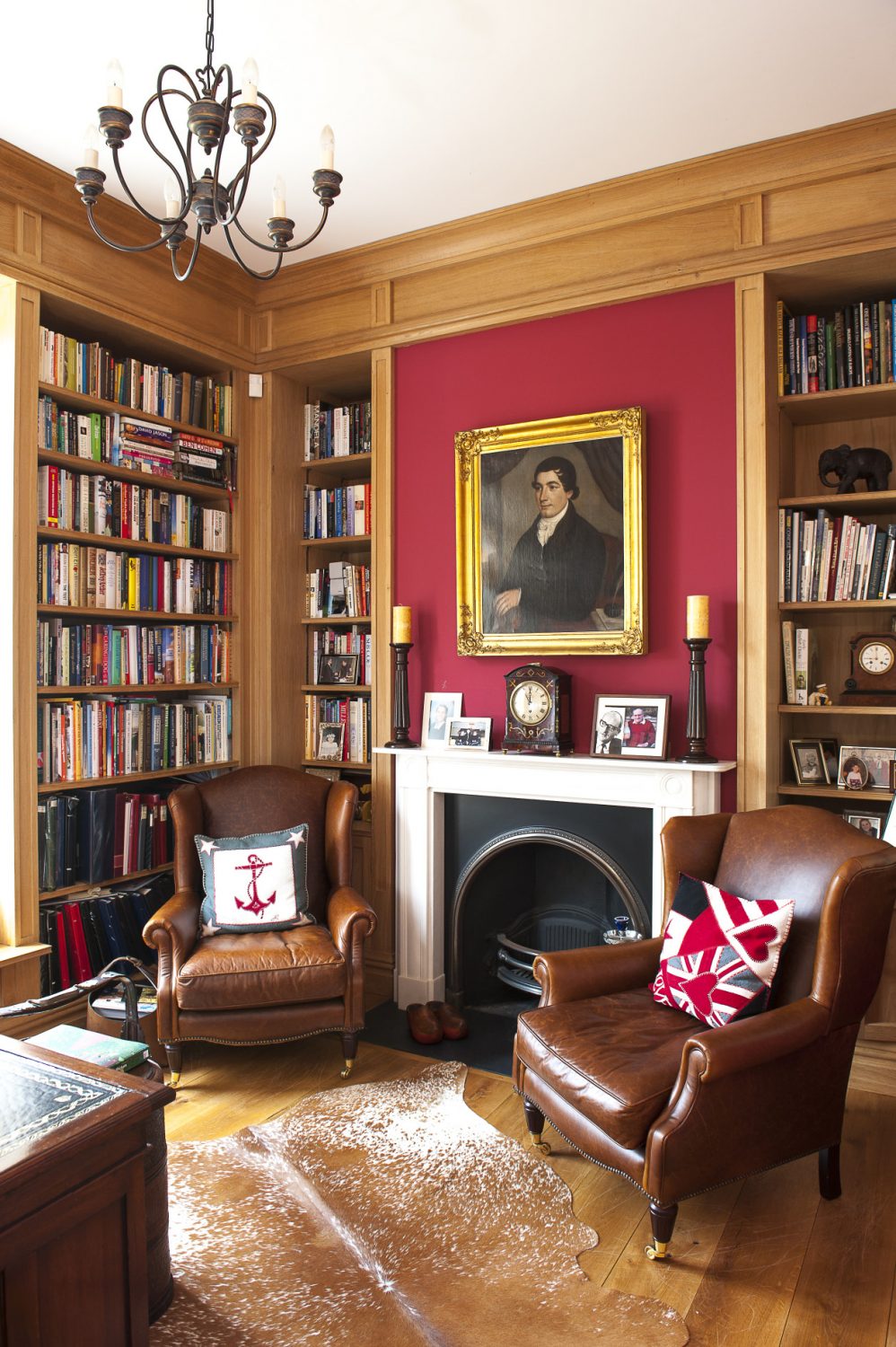 The study is painted in Farrow & Ball Chinese Red, a striking colour that really works and is the perfect backdrop for the oak bookcases