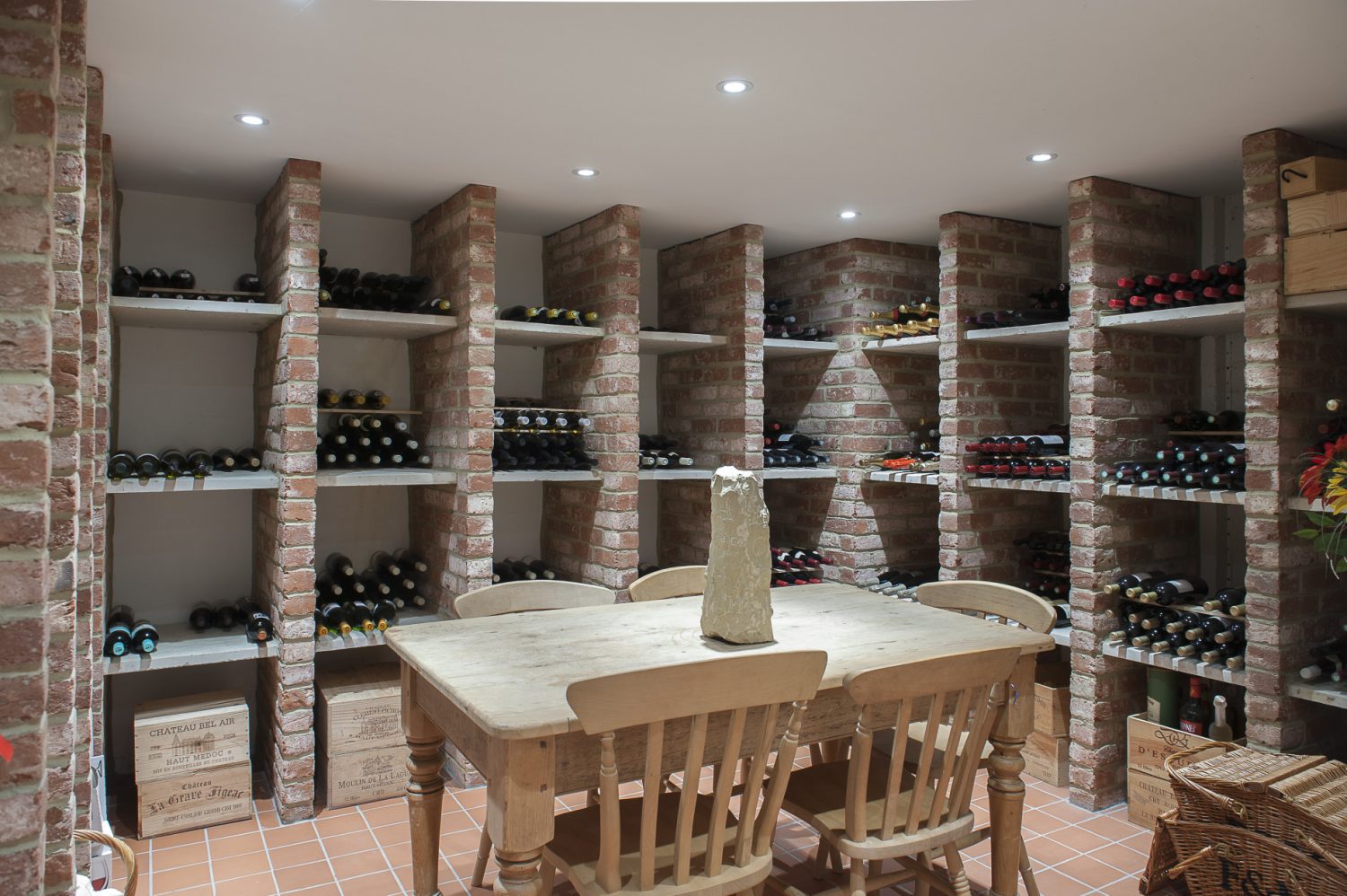 Tucked away down a discreet staircase at the back of the house, there is every wine-lover’s dream; a vast, cool cellar built from brick and stone, where Julian keeps a prized collection of wine. A rustic table is the perfect spot for Julian and fellow wine-lovers to sample favourite wines
