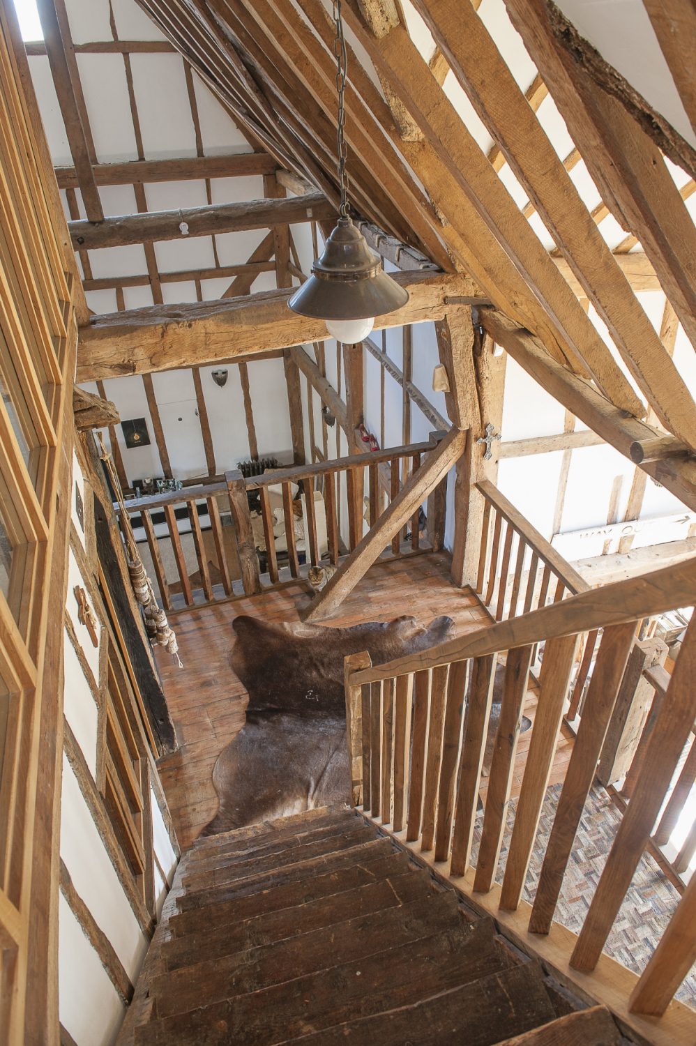 At the top of the barn, reached by its own staircase, is the ‘crash room’ which used to be used largely by the children’s friends for sleepovers and which has a dramatic glazed open studwork wall which overlooks the drawing room.