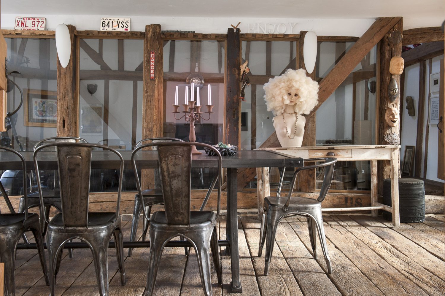 Centrepiece of the heavily timbered dining room is a truly spectacular industrial steel dining table and chairs, made from reclaimed metal by Le Grenier in Lille