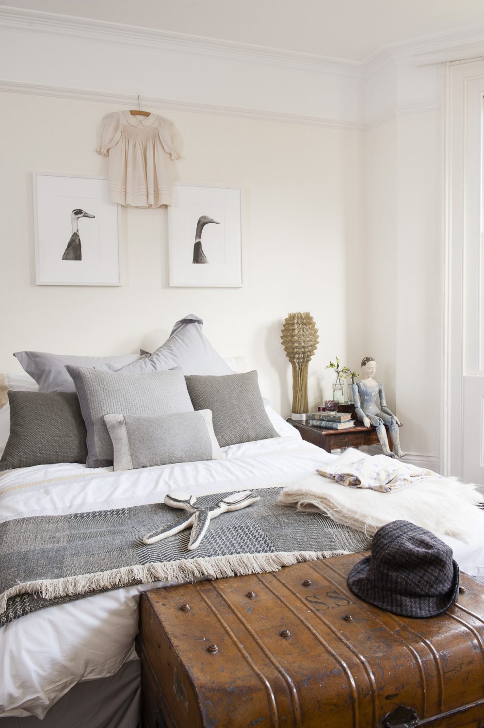 A pair of beautifully illustrated Indian Runner ducks are mounted above the bed in the master bedroom, fitting in perfectly with the room’s cool greys and crisp whites