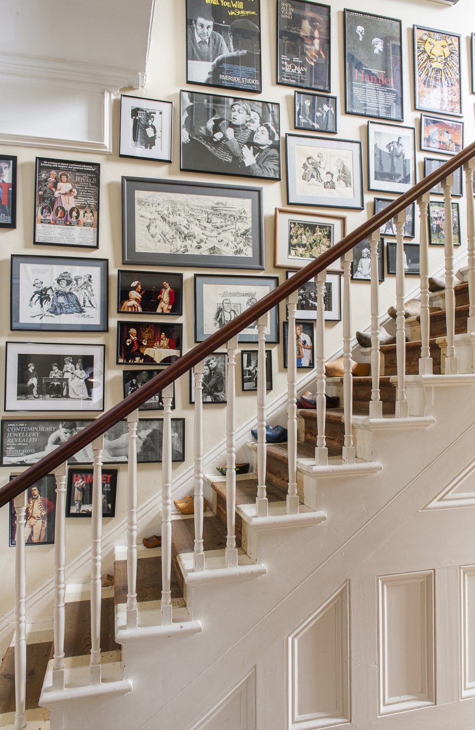 Framed posters and publicity shots line the staircase wall showcasing the many roles Catherine’s husband has played