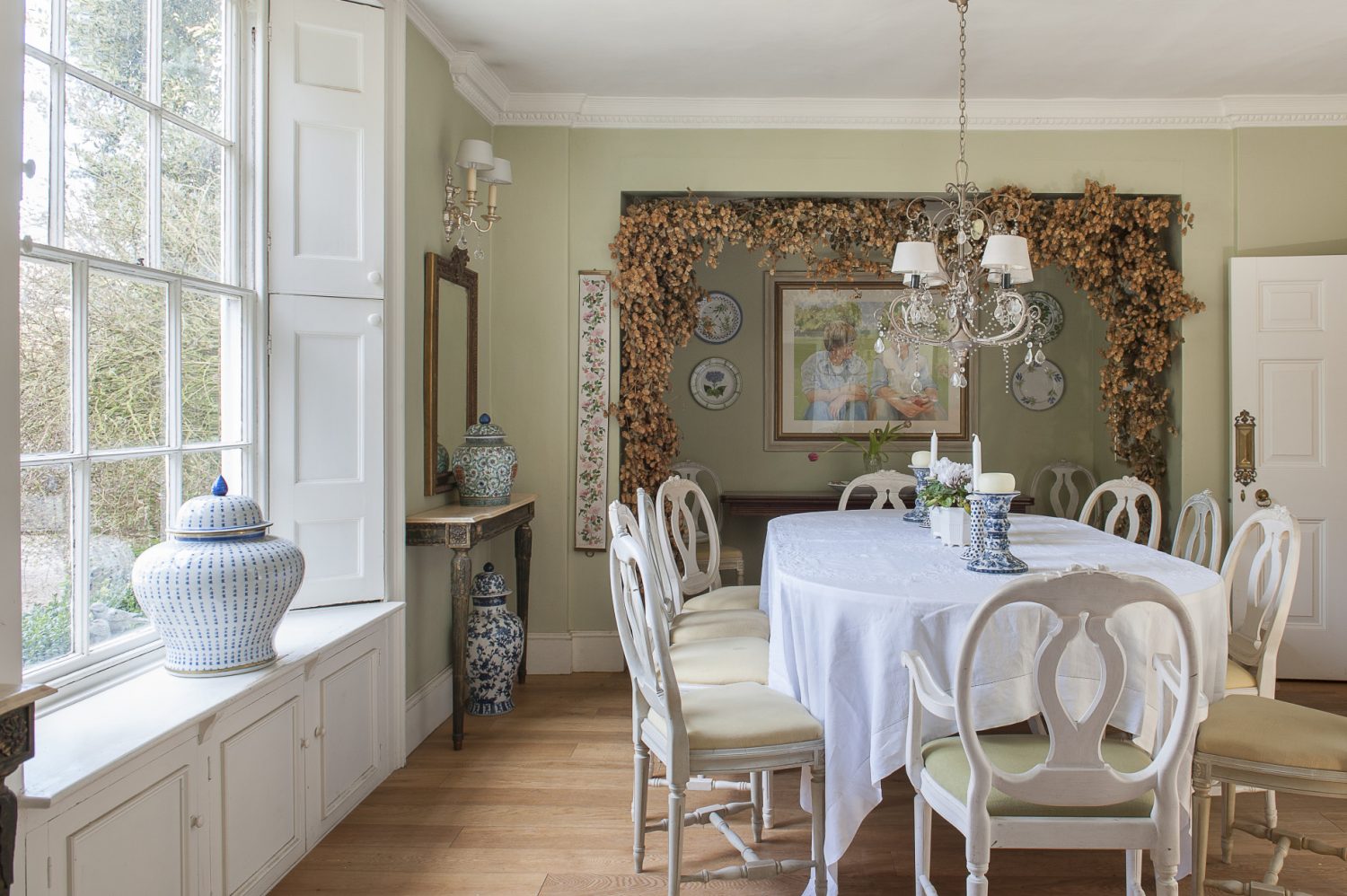 With a view through large sash windows, out over the sweeping gravel drive and front lawns, the dining room seems the perfect room for entertaining