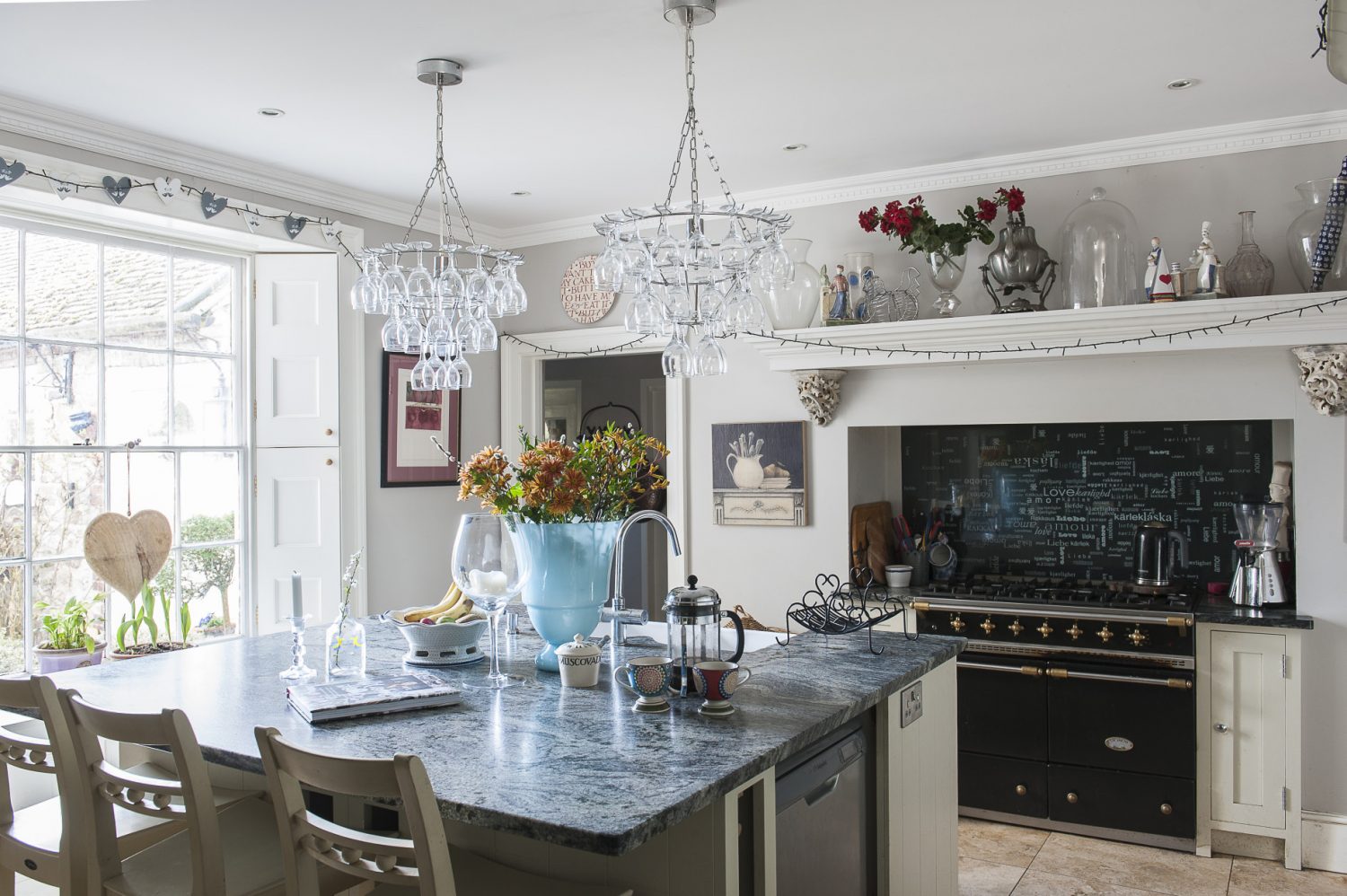 Christel loves to cook, but also lets professional chefs use her kitchen when hosting weddings. The impressive mantelpiece was made especially to sit over the Lacanche range cooker – which came from one of David Beckham’s houses – and the stone corbels on which it rests, came from an antiques fair