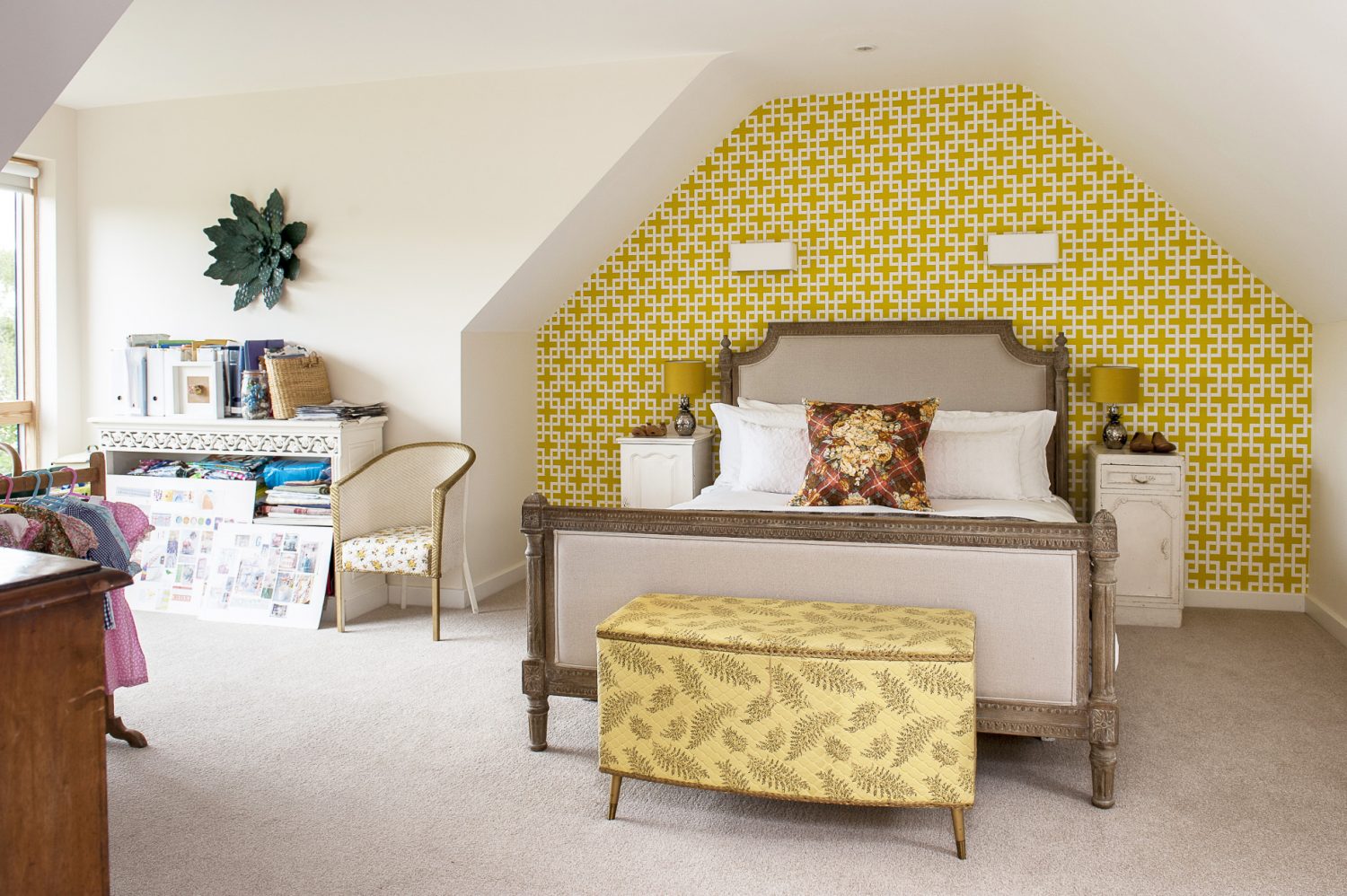 The guest room occupies a vaulted space at the top of the house in which Jenny has appropriated a place by the window to serve as her office. The wall over the Loaf bed is papered in Clarke & Clarke ‘Lattice’ next to which stands an unusual gilt Lloyd Loom chair