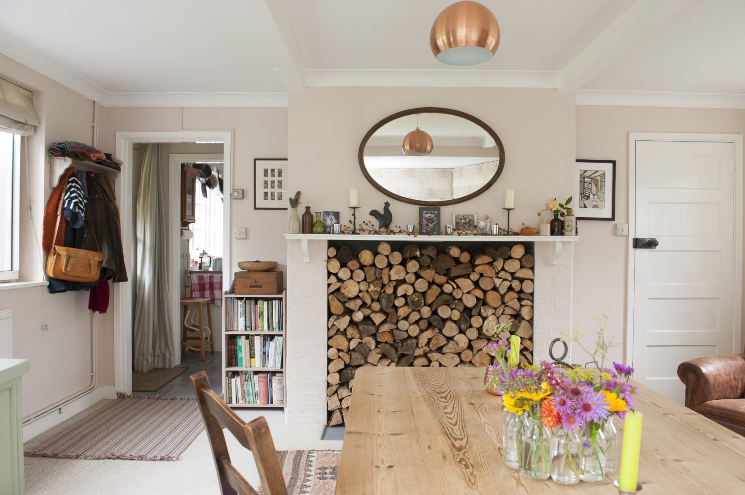 A fireplace which was once home to a kitchen range now acts as the focal point of the front room. A large bay window bathes the room in natural light