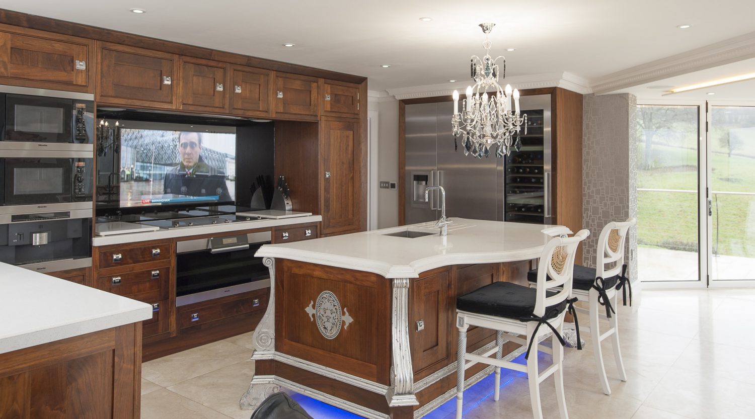 A large TV has been artfully set behind protective glass above the hob so Richard can watch the football while cooking. Also in the kitchen is a full height cabinet that, when opened, reveals more technology than GCHQ – technology that runs the house’s state-of-the-art audio-visual systems