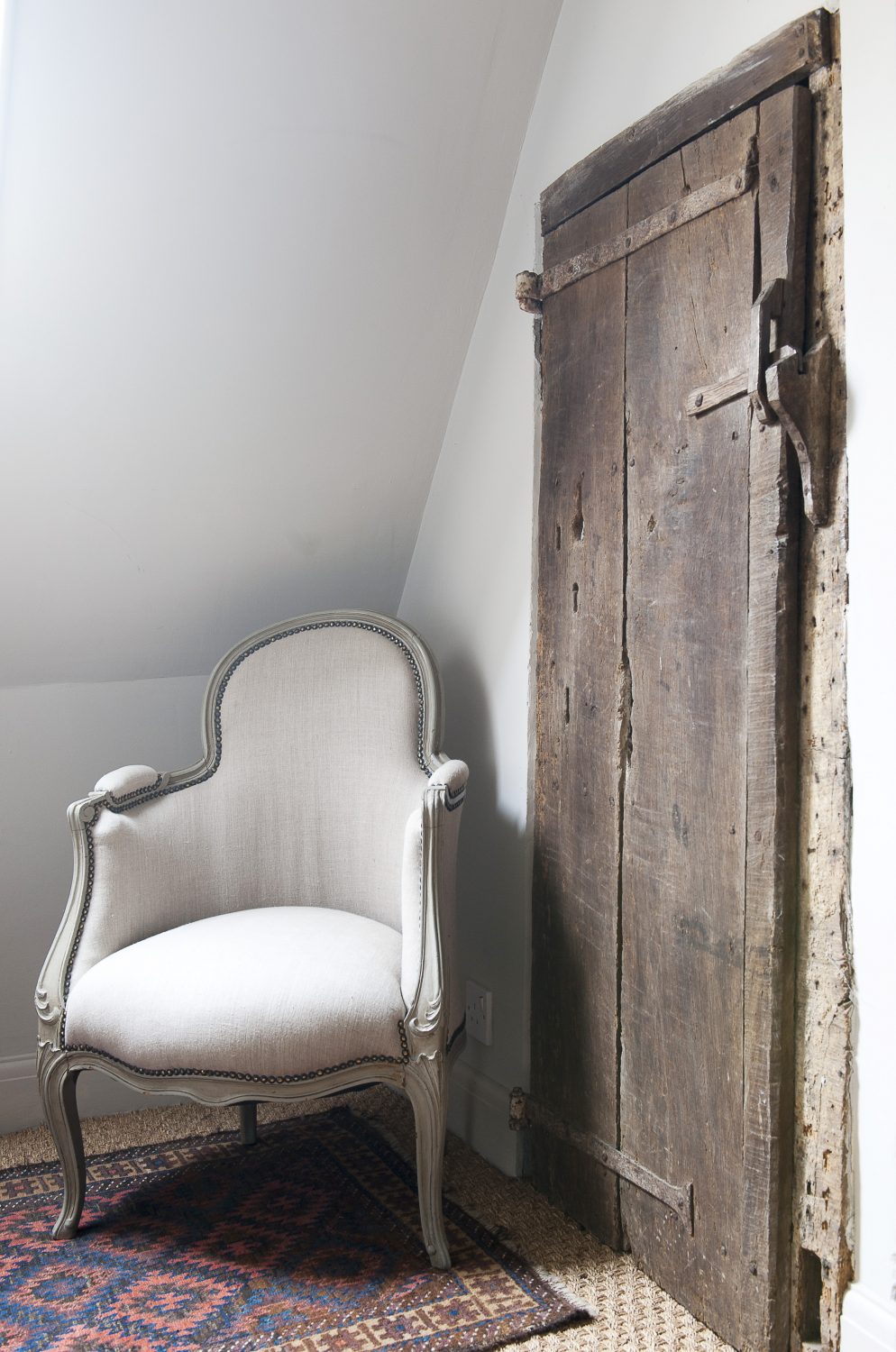 At the top of a small flight of steps on the landing, an old timber ‘hobbit door’ hints at the house’s long history