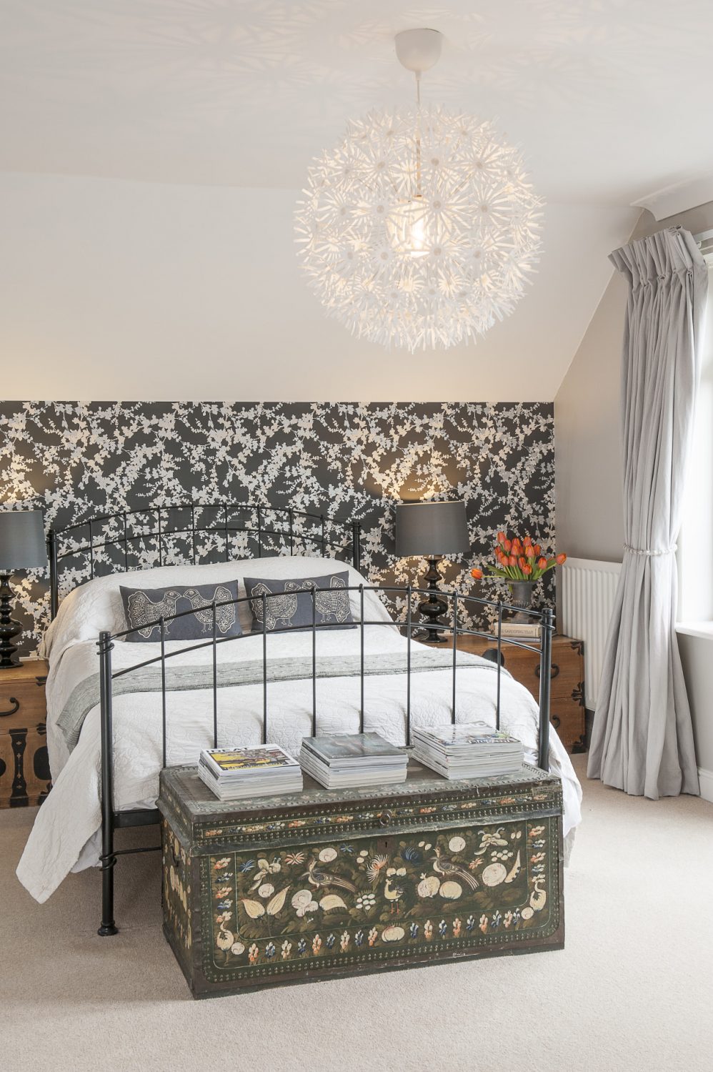 The immaculate guest room and its en suite have been created using products found on the high street – the wallpaper is ‘Hawthorn’ by Laura Ashley. At the end of the bed is an exquisite painted leather chest that belonged to Phoebe’s grandmother