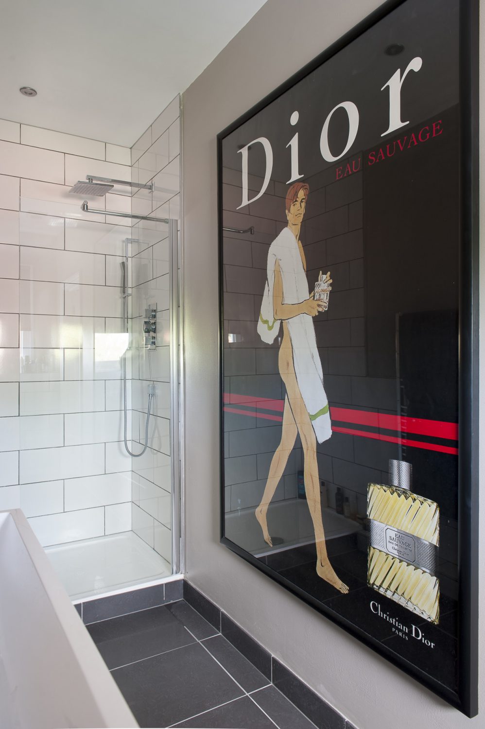 An original Dior poster is all that is needed to decorate the en suite shower room
