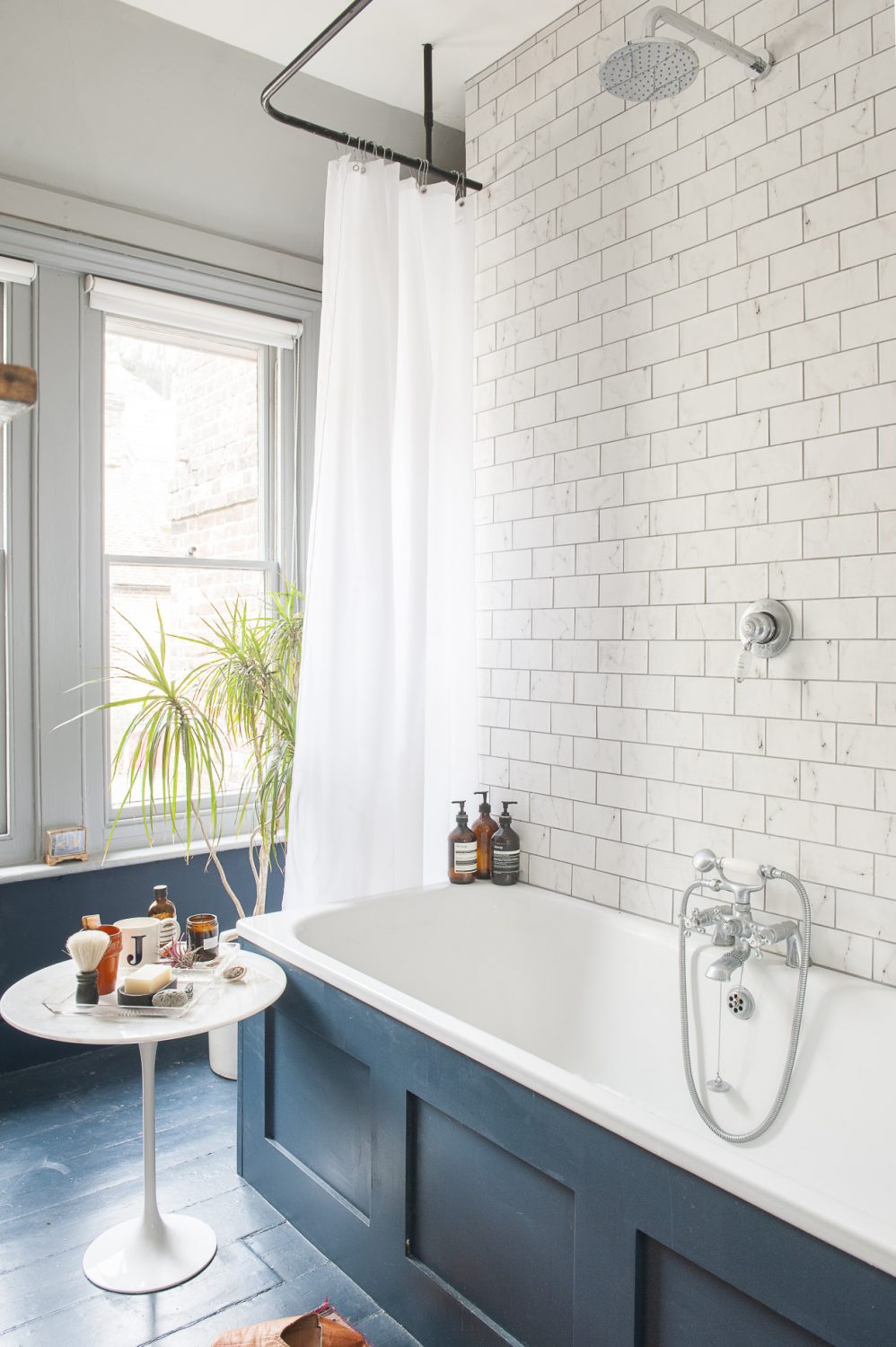 In the sparkling, 1930s-feel bathroom the floorboards are painted in the magnificent Hague Blue by Farrow & Ball.