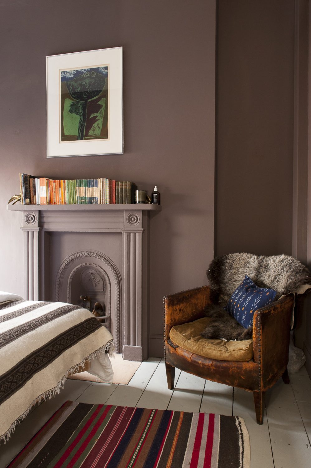 Classic novels sit on a the mantelpiece in the bedroom