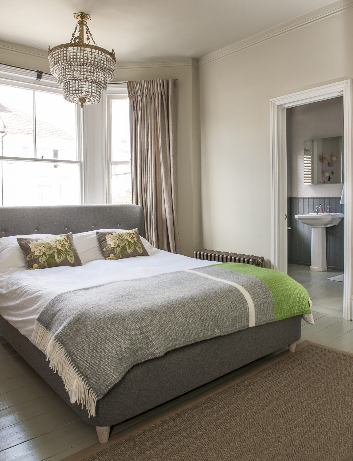 In the master bedroom at the front of the house, the bed is tucked into the bay of the window, maximising the space available and allowing space for the en suite bathroom