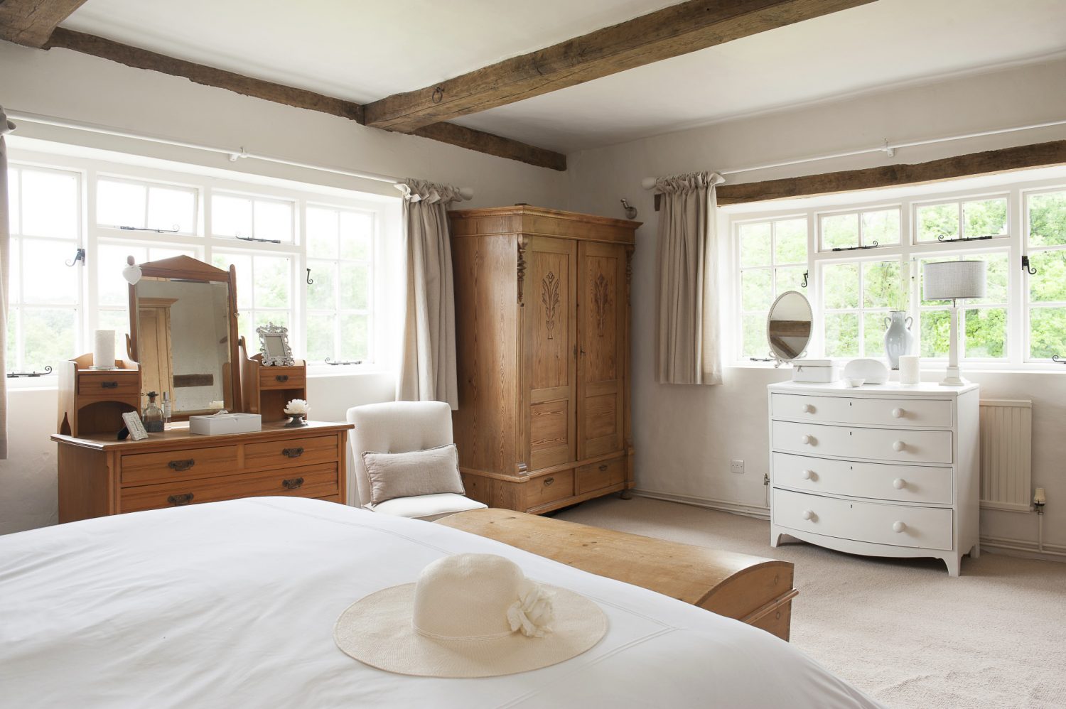 The double-aspect master bedroom looks out over the gardens, which have been a labour of love for Tara and Mark
