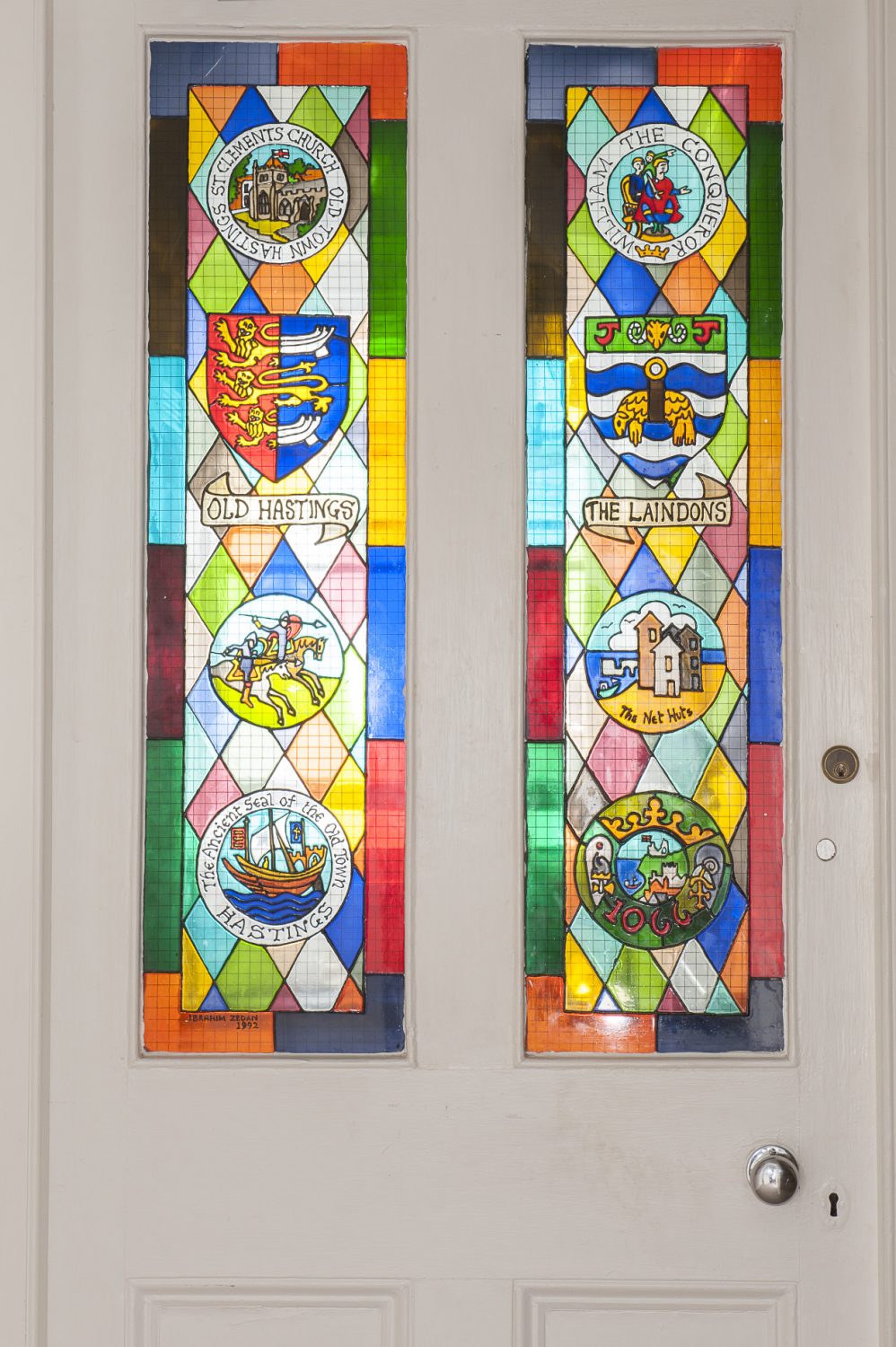Personalised stained glass panels provide a powerful pop of colour in the corridor that separates the bedrooms from the drawing room and dining area