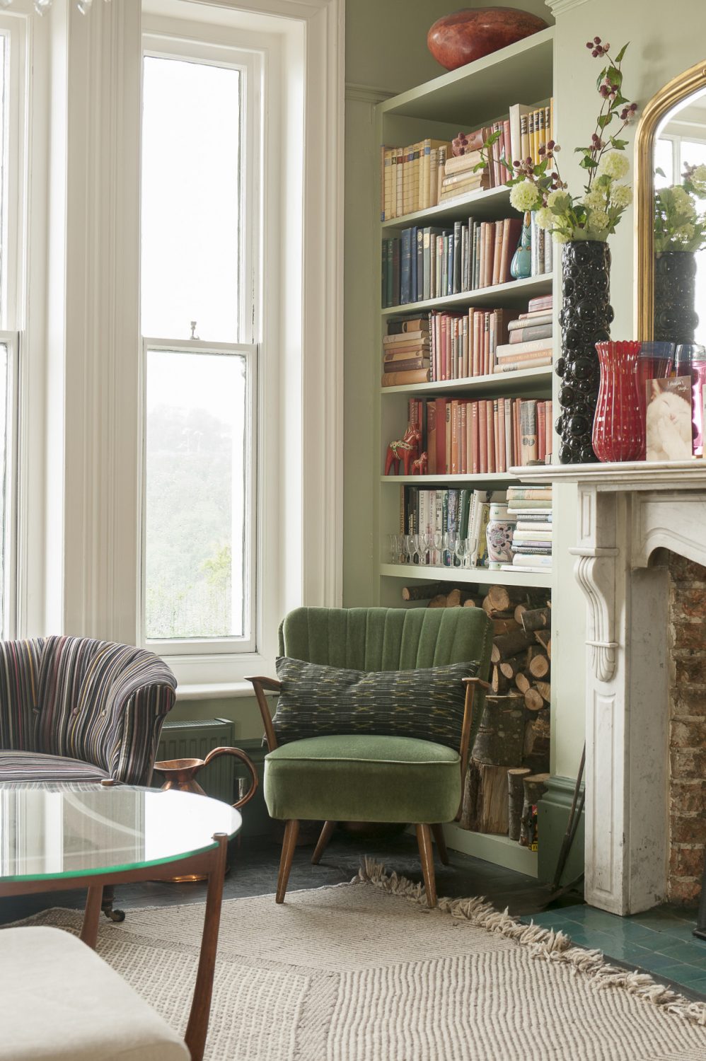The marble fireplace is original to the house, with bookshelves on either side a hint to Ginny’s occupation as a writer, with logs stored beneath. The green chair is from a junk shop in Hastings Old Town. Fresh flowers - and Abigail Ahern’s faux wildflowers - are displayed in Ginny’s collection of vases sourced over the years from Paris flea markets, Shoreditch junk shops and vintage Murano from Venice back streets