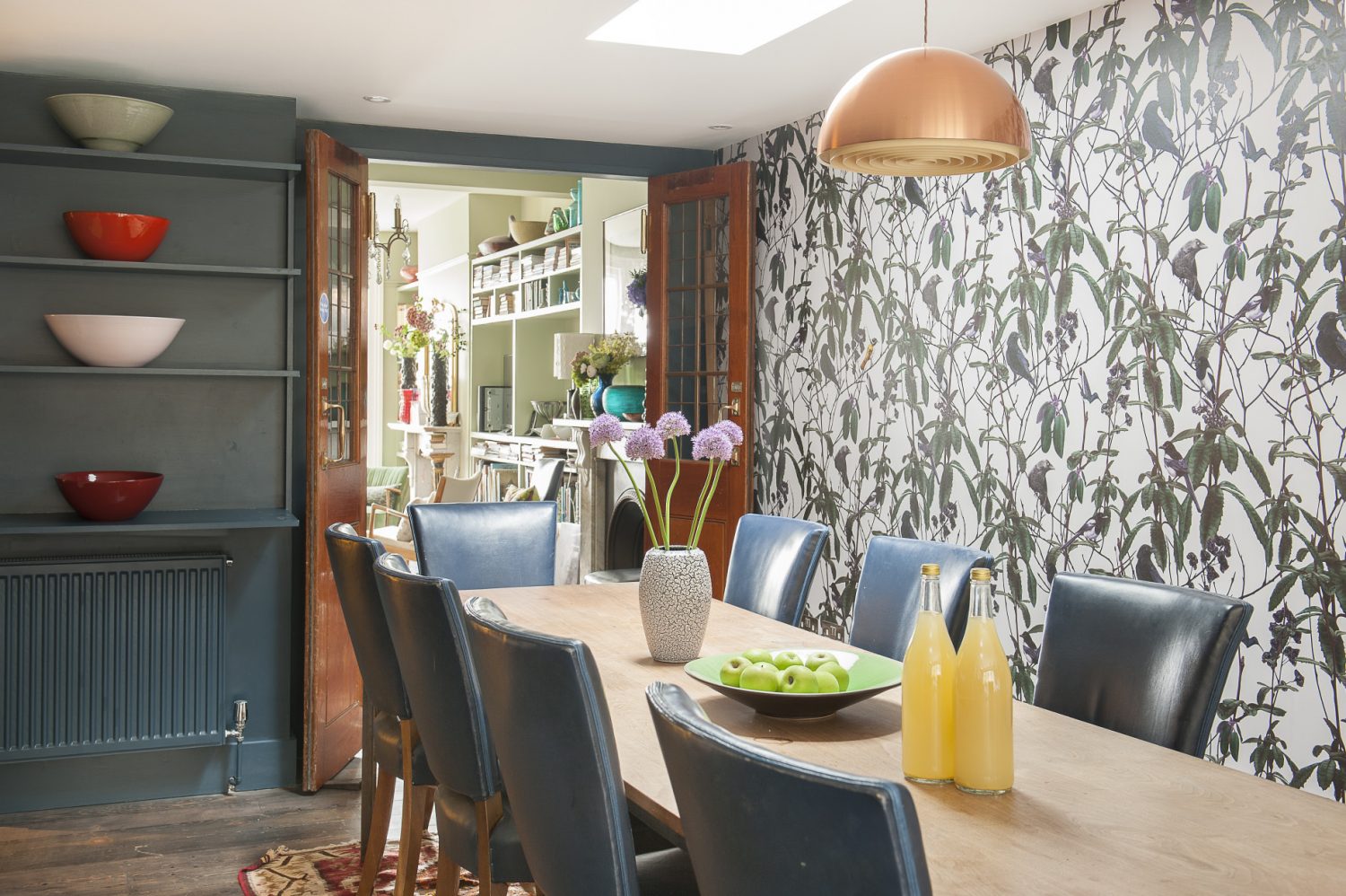 The kitchen-dining area is not a room to hurry through. Along one wall runs a huge refectory table in walnut – originally from the old British Library Reading Room