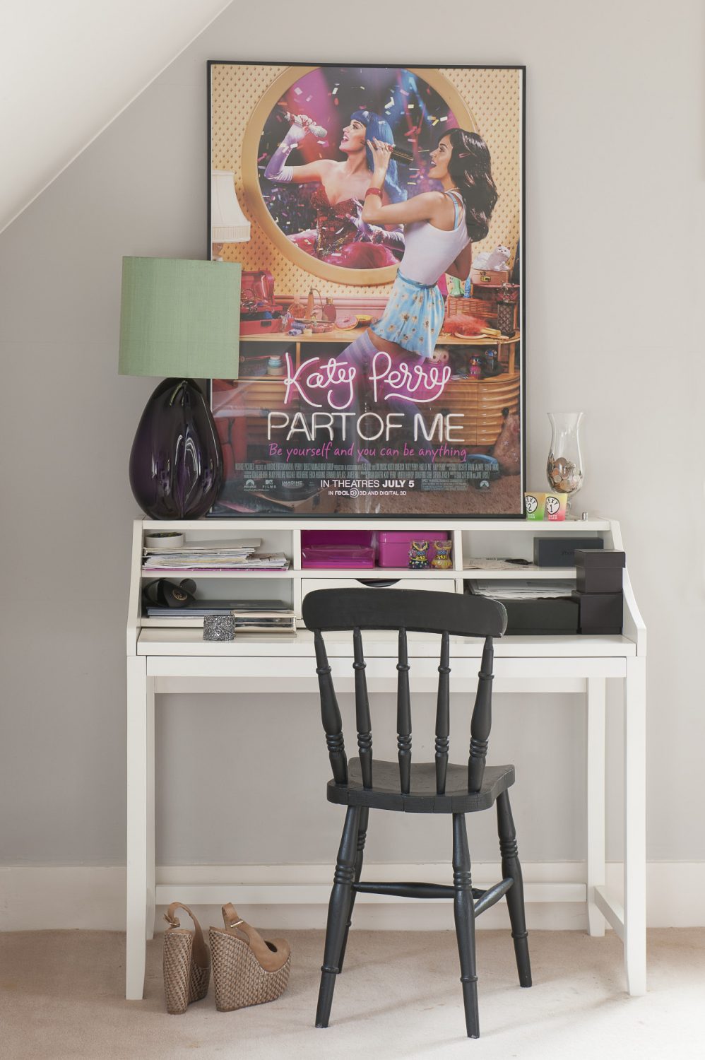 The decorative scheme is continued with the white desk and black chair, with pink accents in the accessories and poster. The lamp is by Porta Romana