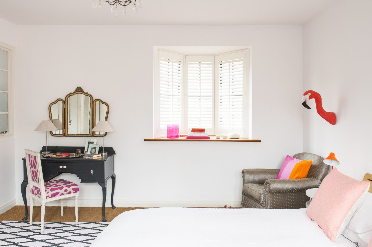 Bright dashes of colour and touches of humour, such as the flamingo’s head protruding from the wall, prevent the rooms feeling at all austere – despite the liberal use of white paint on the walls