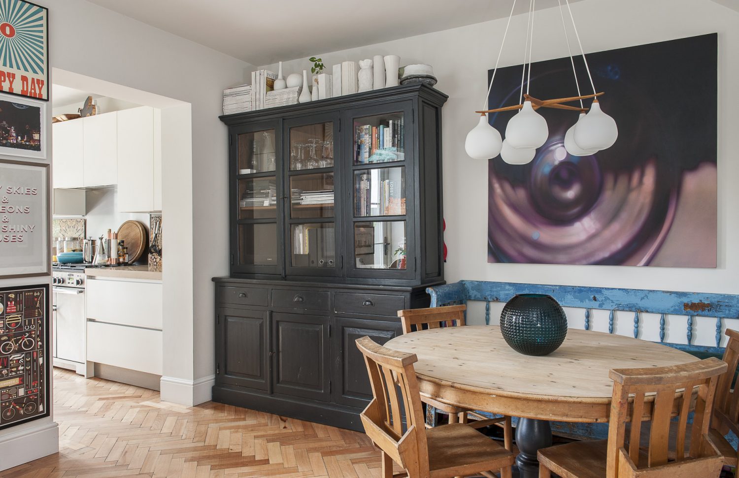 The open-plan kitchen and dining area both feature reclaimed parquet flooring, interconnecting the rooms and making the whole area feel light and bright. The kitchen, which now opens directly on to the garden was once dark and cluttered and accessed via a dining room