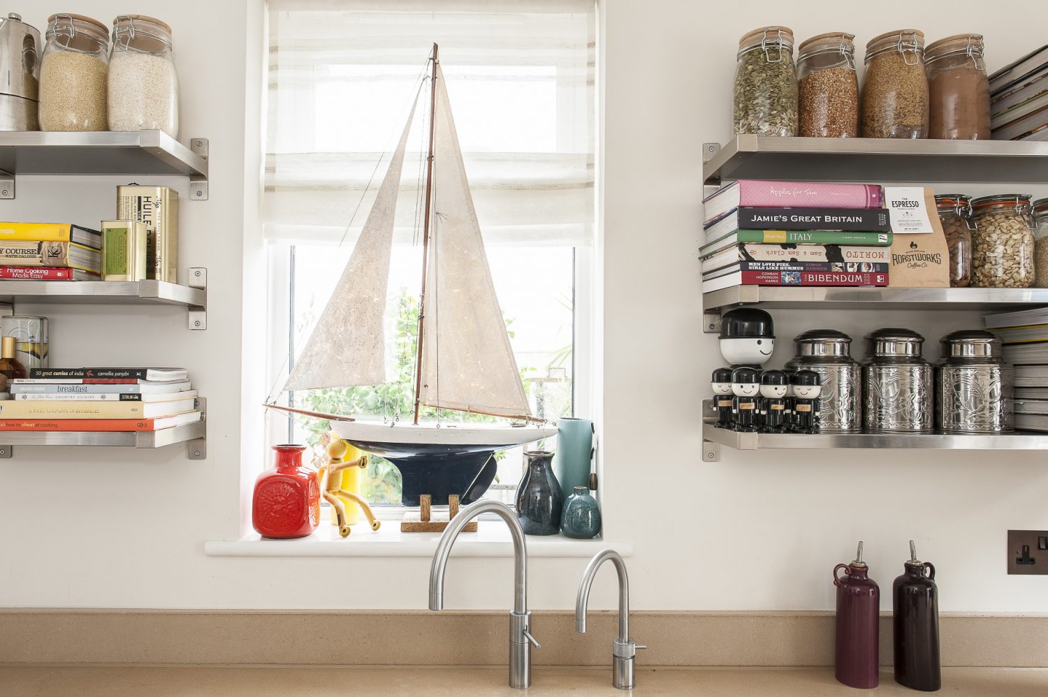 The neutral, simple kitchen units are from Krieder in Tunbridge Wells with open shelving as a design feature in itself and home to colourful ingredients and recipes books, as well as a collection of retro Homepride ‘Freds’