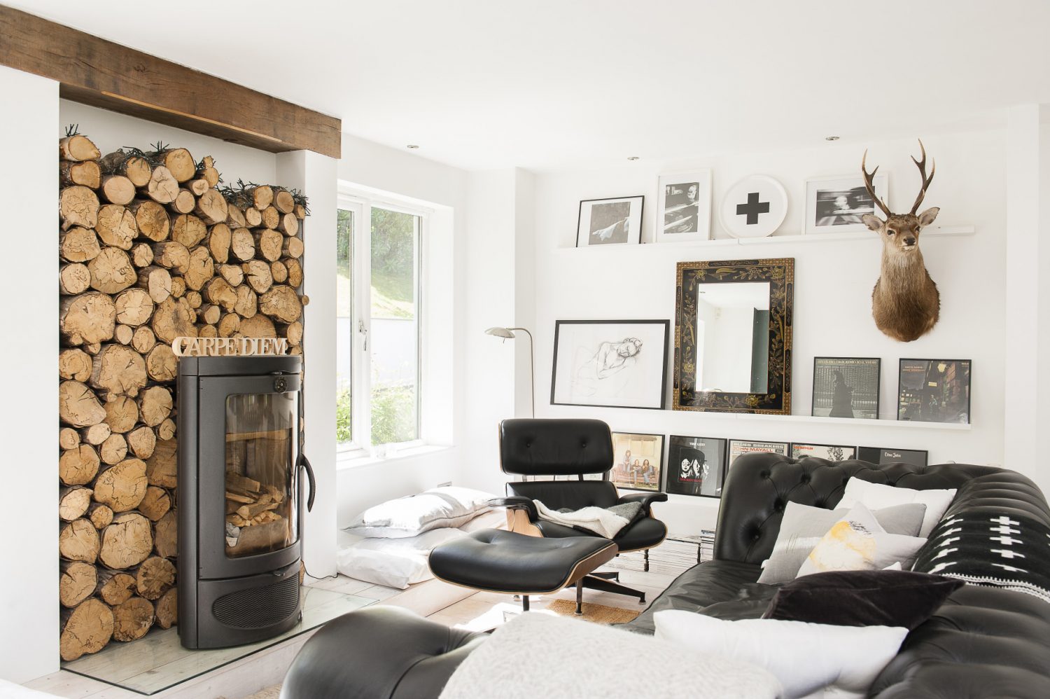 Centrepiece of the snug is an elegant contemporary Austroflamm woodburner backed by a bank of logs. Keeping it company are a Conran four-seater black leather Chesterfield and an Eames recliner. On the wall among the couple’s framed classic vinyls is one of Sue’s own charcoals.