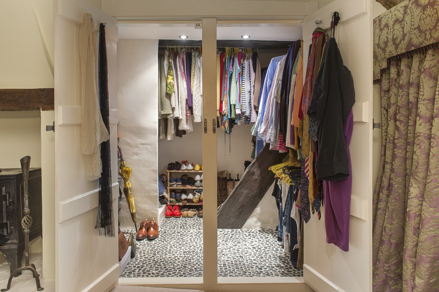 Sarah used a darker version of the pebble flooring in the wet room for the couple’s walk-in wardrobe