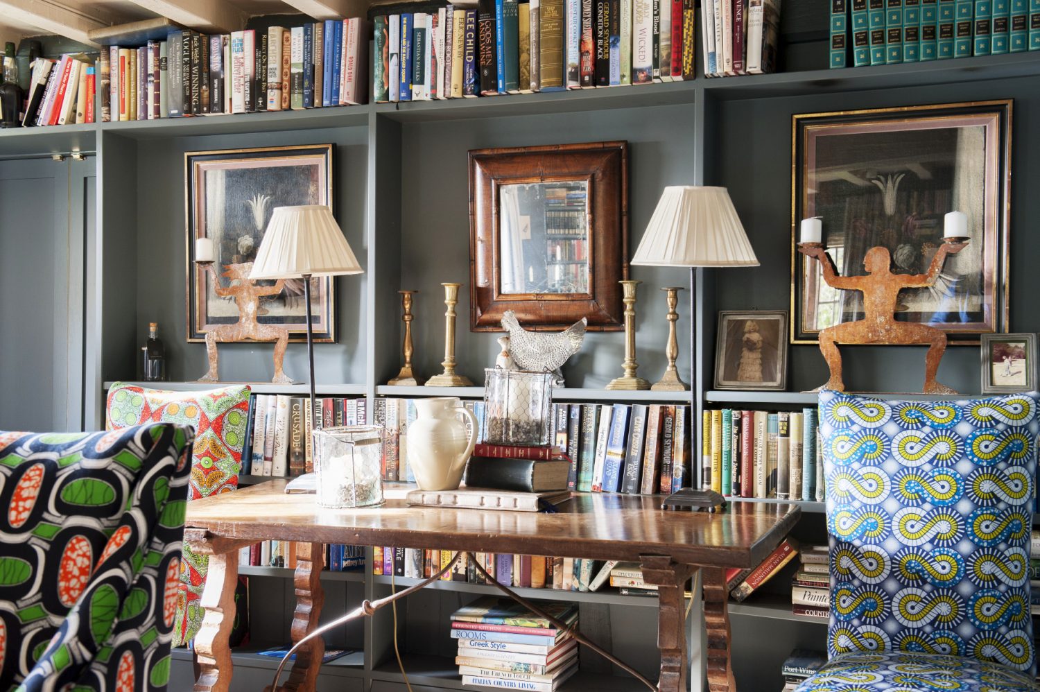 In the dining room the walls and bookcases are painted a dark grey – though Ally has managed to keep the room from feeling dark and oppressive by painting the ceiling and its beams off-white