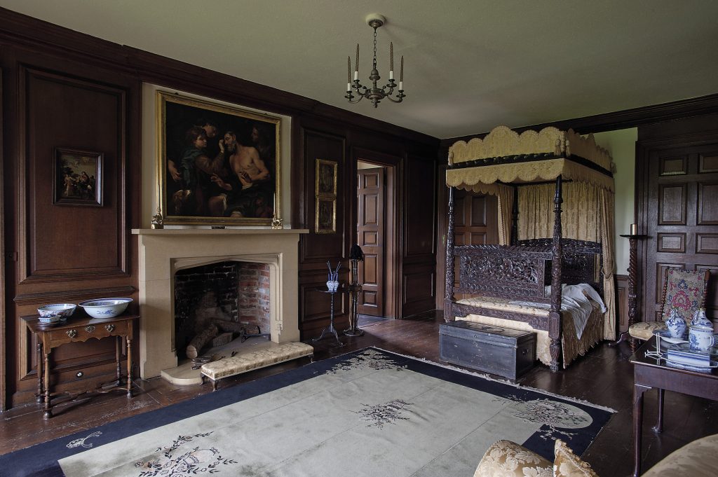 The State Bedroom of Queen Anne is entered through a door that leads off the State Drawing Room and features an intricately carved four-poster bed, at the base of which is a leather trunk studded with the Queen’s cipher on the lid